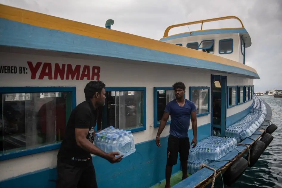 Bottled water is loaded onto a boat for delivery to another island | Photo: hrw.org