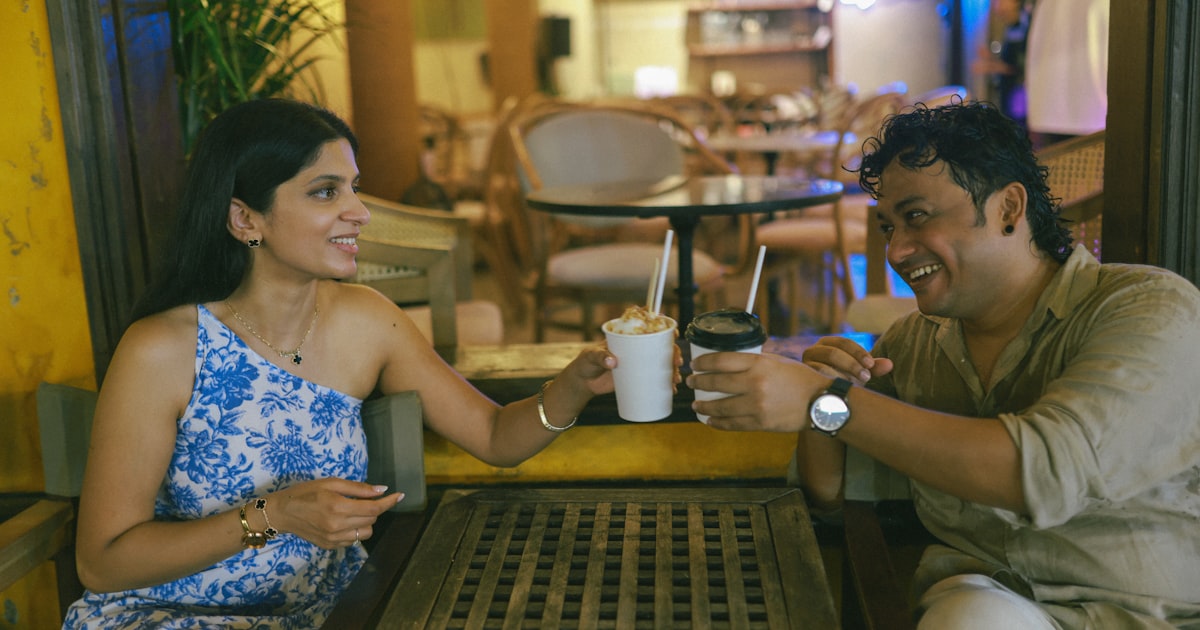 Two people having chai and conversation at a cafe, warm and relaxed arranged marriage meeting setting