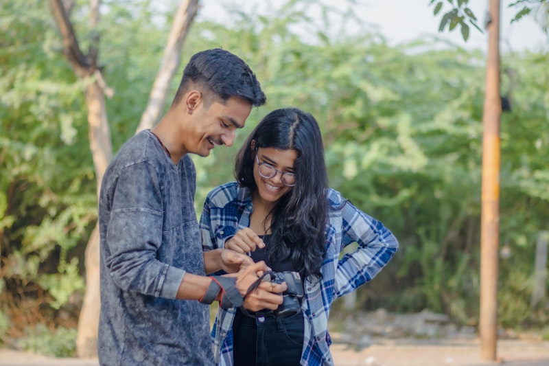 Young Indian couple having a modern arranged marriage video call on a smartphone with chai in the background