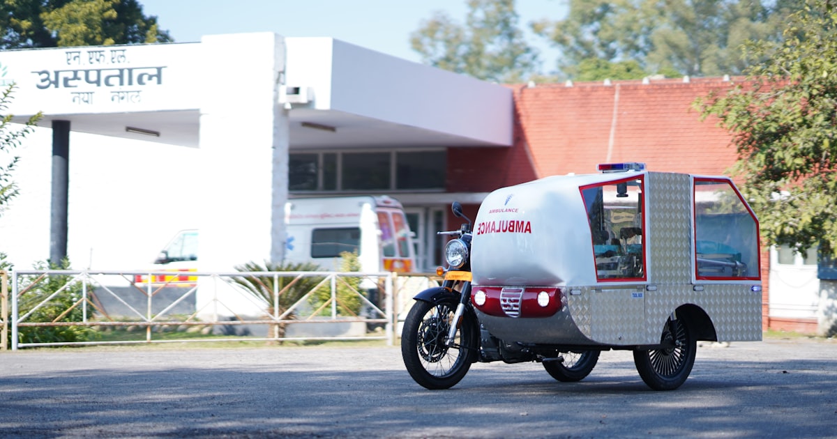Ambulance vehicle parked outside hospital building.