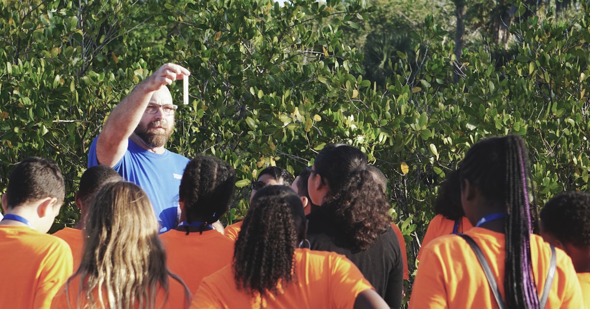 man standing in front of women