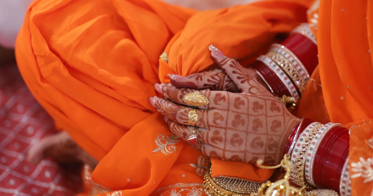 A close up of a person wearing an orange outfit