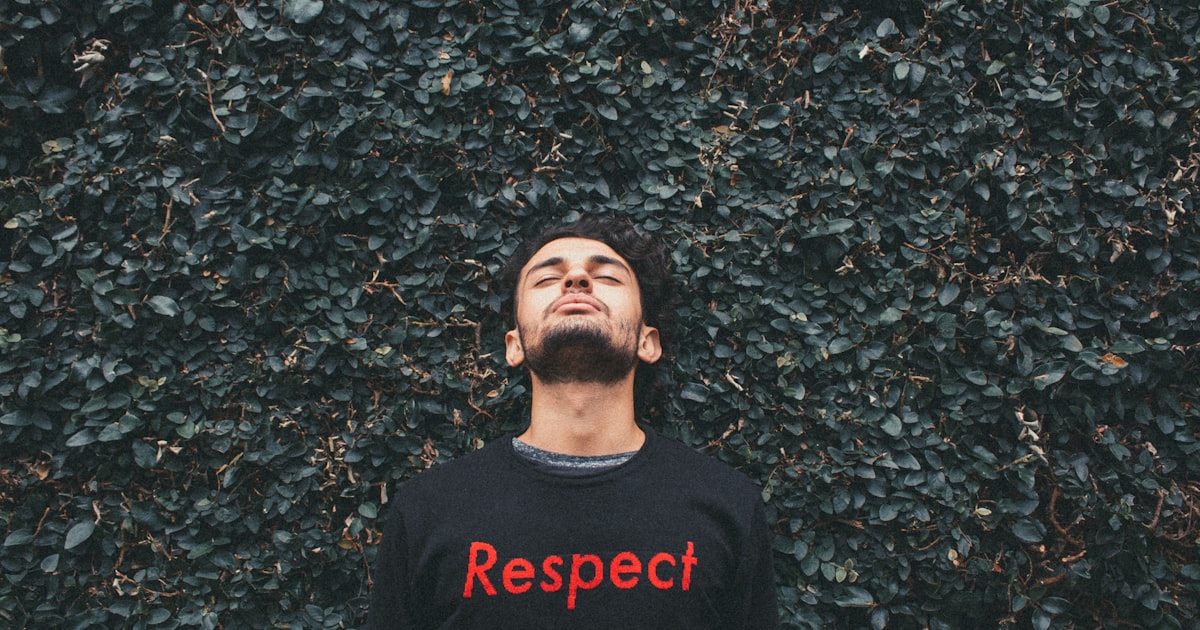 person standing behind green leafed plants