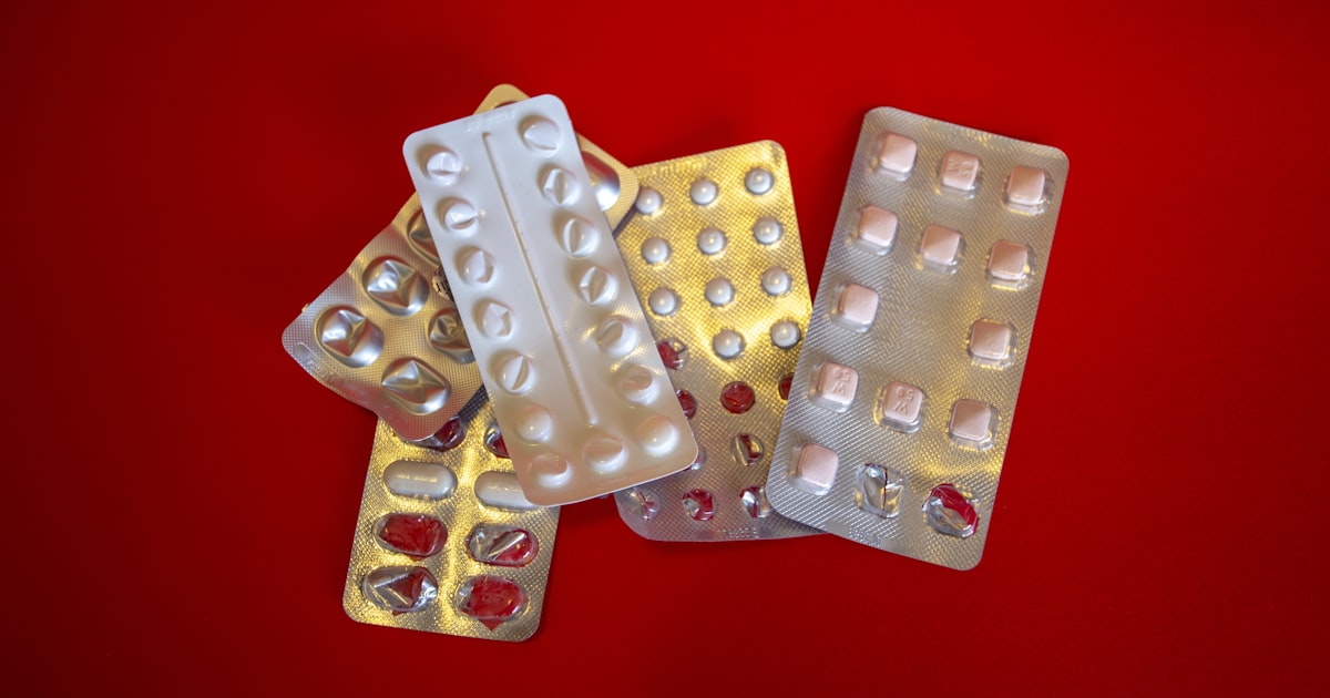 silver blister pack on red textile