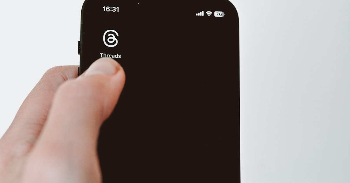 A hand firmly pressing a phone screen showing a block contact button in a calm steady setting